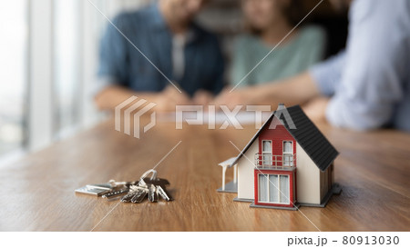 Close up of key and tiny toy house on table Close up of key and tiny toy house on table 80913030