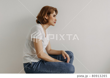 Cool looks woman in white t-shirt and jean relax in her apartment room. Cool looks woman in white t-shirt and jean relax in her apartment room. 80913265