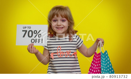 Kid child girl showing shopping bags and Up To 70 Percent Off inscriptions banner text, Black Friday 80913732