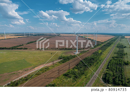 Aerial view of Wind power turbine is a popular sustainable, renewable energy source on beautiful cloudy sky. Wind power turbines generating clean renewable energy for sustainable development. 80914735