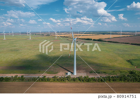 Aerial view of Wind power turbine is a popular sustainable, renewable energy source on beautiful cloudy sky. Wind power turbines generating clean renewable energy for sustainable development. 80914751