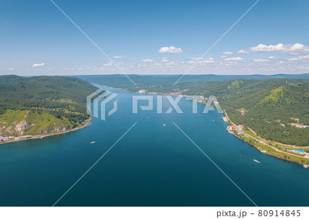 The Angara River is a major river in Siberia leaving Lake Baikal near the settlement of Listvyanka. Panoramic aerial view. 80914845