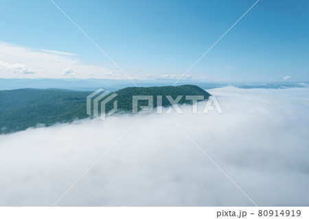 Flying through the clouds above mountain tops. High peaks wonderful morning sunrise natural Landscape 80914919