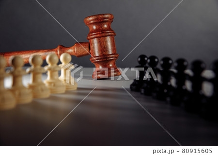 Chess pieces and law gavel on a table Chess pieces and law gavel on a table 80915605