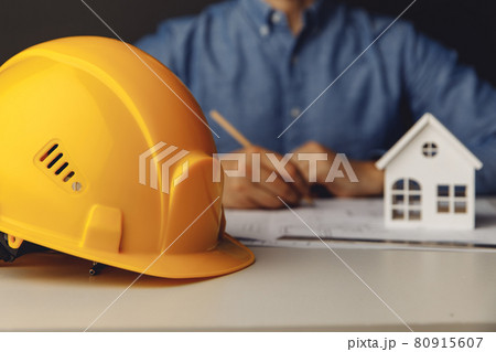 Architect engineer working on blueprint at his office 80915607