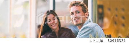 Happy young man with woman friend at cafe city lifestyle students adults banner panoramic header smiling caucasian guy with asian girl 80916321