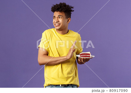 Celebration, party and holidays concept. Oh gosh its disgusting. Portrait of reluctant and displeased young man turn away from awful bad taste cake, show refusal, rejection or stop sign 80917090