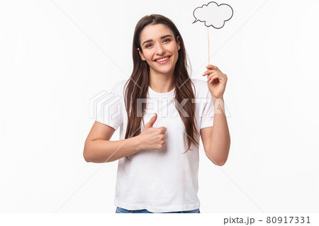 Entertainment, fun and holidays concept. Portrait of satisfied cute young girl with long hair, holding imagination comment cloud, show thumbs-up, have interesting idea, think-up solution Entertainment, fun and holidays concept. Portrait of satisfied cute young girl with long hair, holding imagination comment cloud, show thumbs-up, have interesting idea, think-up solution 80917331