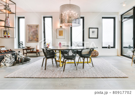 Spacious dining room with stylish table and chairs in modern apartment 80917702
