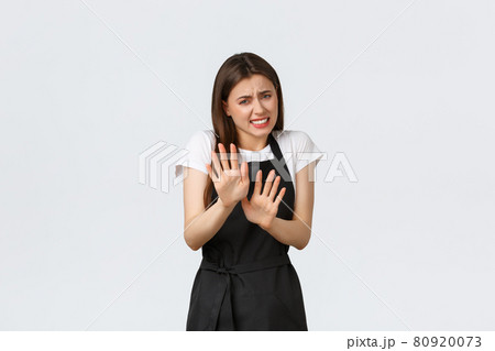 Grocery store employees, small business and coffee shops concept. Reluctant and displeased saleswoman show rejection gesture, shaking hands disappointed, refuse offer feeling awkward 80920073