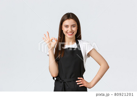 Grocery store employees, small business and coffee shops concept. Cheerful happy smiling barista saying alright, showing okay gesture. Cafe worker guarantee makes best drinks in town Grocery store employees, small business and coffee shops concept. Cheerful happy smiling barista saying alright, showing okay gesture. Cafe worker guarantee makes best drinks in town 80921201