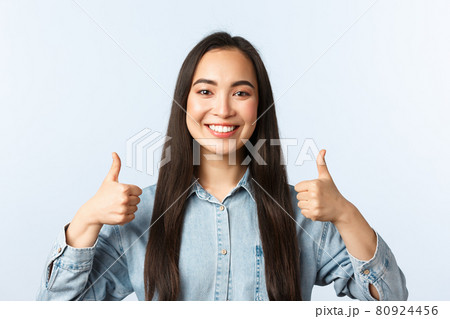 Lifestyle, people emotions and beauty concept. Cheerful friendly-looking asian girl smiling happy, show thumbs-up in approval, agree and support friend choice, white background Lifestyle, people emotions and beauty concept. Cheerful friendly-looking asian girl smiling happy, show thumbs-up in approval, agree and support friend choice, white background 80924456