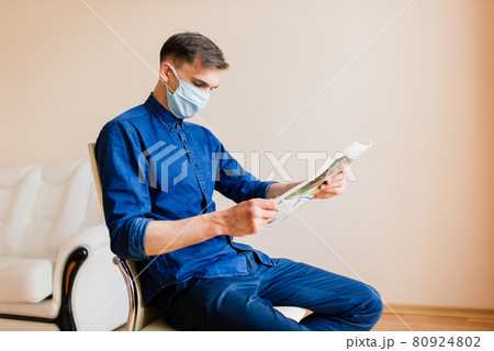 Man working on laptop wearing mask from home office 80924802