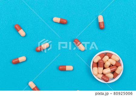 Pharmaceutical Industry and Medicinal Products - Colored Pills on Blue Table 80925006
