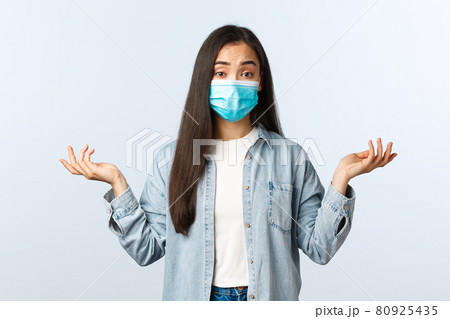 Social distancing lifestyle, covid-19 pandemic everyday life and leisure concept. Confused attractive asian woman in medical mask dont know, shrugging shoulders clueless Social distancing lifestyle, covid-19 pandemic everyday life and leisure concept. Confused attractive asian woman in medical mask dont know, shrugging shoulders clueless 80925435