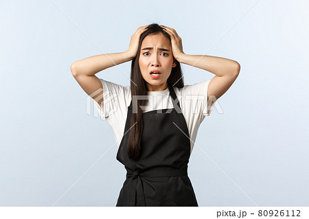 Coffee shop, small business and startup concept. Troubled and distressed young asian barista, female cafe staff having trouble, grab head in panic, frowning and staring desperate camera 80926112
