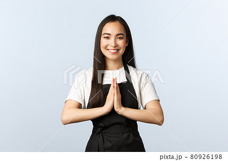 Coffee shop, small business and startup concept. Young smiling asian female cafe employee, staff at restaurant hope everyone staying safe on quarantine, praying with hands in plead gesture Coffee shop, small business and startup concept. Young smiling asian female cafe employee, staff at restaurant hope everyone staying safe on quarantine, praying with hands in plead gesture 80926198