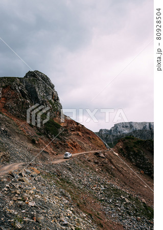 Driving off road car on high altitude mountain top 80928504