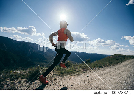 Young woman ultramarathon runner running at mountain top 80928829