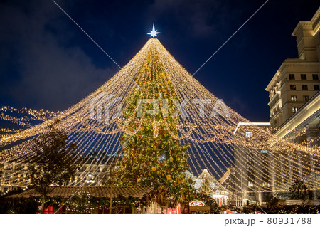 christmas tree in the center of town fair in night 80931788