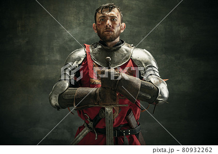 Portrait of one brutal bearded man, medeival warrior or knight with dirty wounded face 80932262