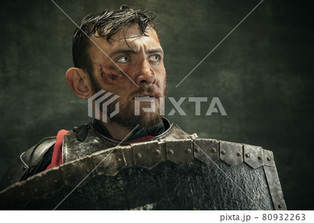 Portrait of one brutal bearded man, medeival warrior or knight with dirty wounded face 80932263