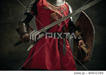 Cropped image. Portrait of one brutal man, medeival warrior or knight with sword and shield 80932269