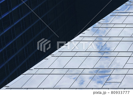 Modern Building Glass Facade reflection with sky Architecture details 80933777
