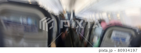 Passengers flying in aircraft cabin back view blurred background 80934197