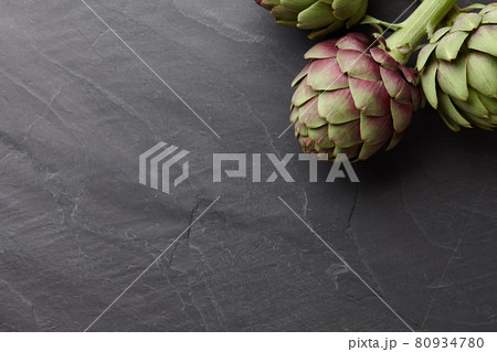 Fresh artichokes on dark gray stone background 80934780