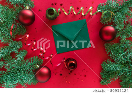 Merry Christmas happy New Year concept. Christmas composition. Christmas letter, baubles, fir tree branches on red surface. Top view 80935124