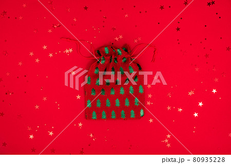 Christmas bag toy minimal composition. Christmas textile decorations on red surface. Top view, flat lay 80935228