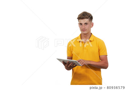 young man in yellow shirt using tablet. With an isolated white background 80936579