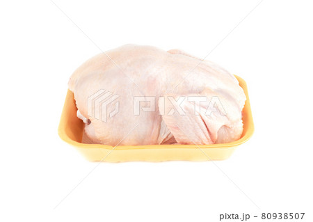 A whole fresh chicken in a yellow plastic tray. 80938507