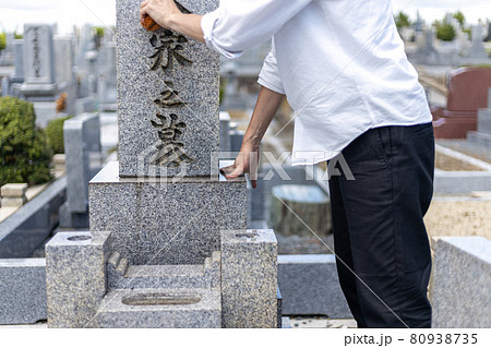 お墓参りに来てたわしでお墓の掃除をしている男性 お墓参りに来てたわしでお墓の掃除をしている男性 80938735