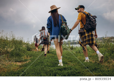 Young man and woman, family couple walking, strolling together outskirts of city, at summer forest. Active lifestyle, travel, eco, relationship concept 80939034