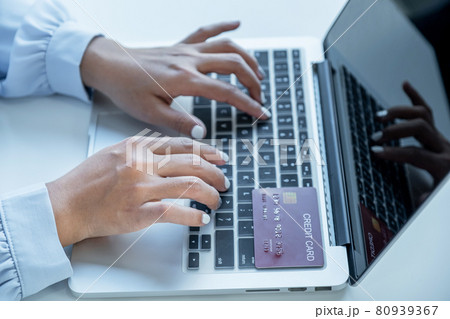 Consumer woman hand use laptop , Ready to a mock up credit card spending pay online finance shopping according to discount products via laptop from home office 80939367