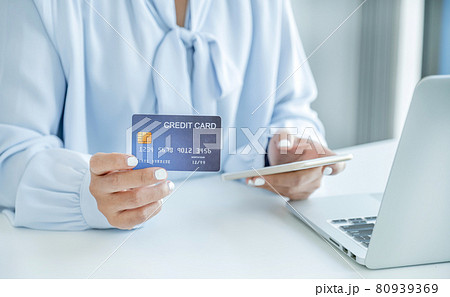 Consumer woman hand holding a mock up credit card, ready to spending pay online finance shopping according to discount products via smart phone from home office Consumer woman hand holding a mock up credit card, ready to spending pay online finance shopping according to discount products via smart phone from home office 80939369