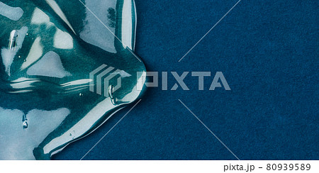 Transparent hyaluronic acid gel on a blue background. 80939589