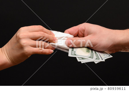 Addict buys a dose of drugs, white powder in a sachet on a black background. Addict buys a dose of drugs, white powder in a sachet on a black background. 80939611