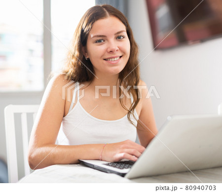 Young woman working on laptop at home Young woman working on laptop at home 80940703