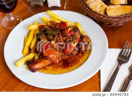 Baked pork shank with vegetables and french fries Baked pork shank with vegetables and french fries 80940783