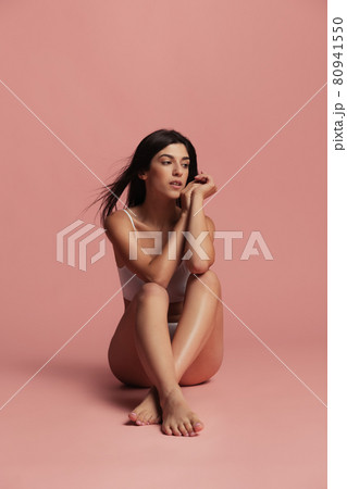 Sports, yoga and healthy lifestyle. Young beautiful sportive woman in lingerie posing isolated over pink studio background. Natural beauty concept. Sports, yoga and healthy lifestyle. Young beautiful sportive woman in lingerie posing isolated over pink studio background. Natural beauty concept. 80941550