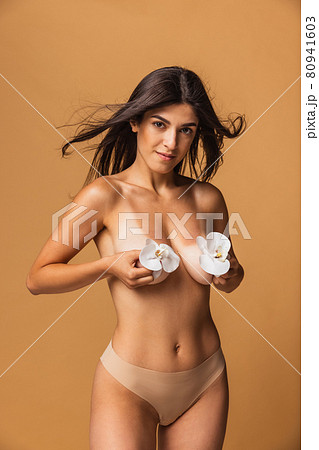 Cropped portrait of young, slim, healthy and beautiful woman isolated over brown background. Cropped portrait of young, slim, healthy and beautiful woman isolated over brown background. 80941603