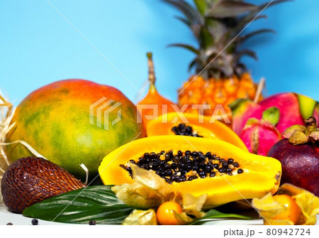 Papaya, Dragon Fruit, Mango, Mangosteen, Winter Cherry, Granadilla, Salak and Pineapple. Fresh Tropical Fruits. On blue background. Top view. Fruit Background 80942724