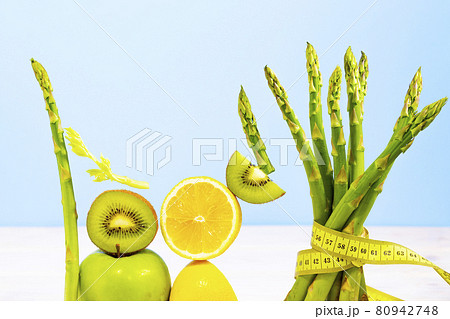 Fresh Vegetables and Fruits such as Lemon, Kiwi, Asparagus with Measuring tape. Equilibrium floating food. Balance. Copy Space. Vegetarianism 80942748