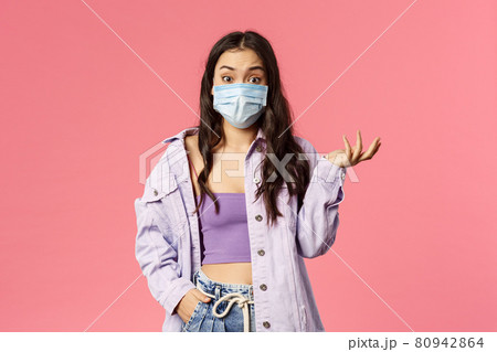 Covid19, quarantine, people concept. Surprised young woman in medical face mask stay safe during coronavirus pandemia outbreak, look ambushed wear medical mask, raise hand in amazement Covid19, quarantine, people concept. Surprised young woman in medical face mask stay safe during coronavirus pandemia outbreak, look ambushed wear medical mask, raise hand in amazement 80942864