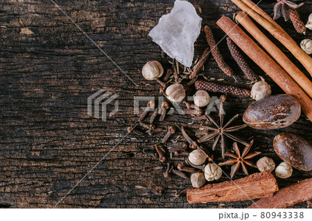 Chinese Indian Thai Dried mix herbal medicine or food ingredient or aroma extract on old wooden background with space for text. Chinese Indian Thai Dried mix herbal medicine or food ingredient or aroma extract on old wooden background with space for text. 80943338