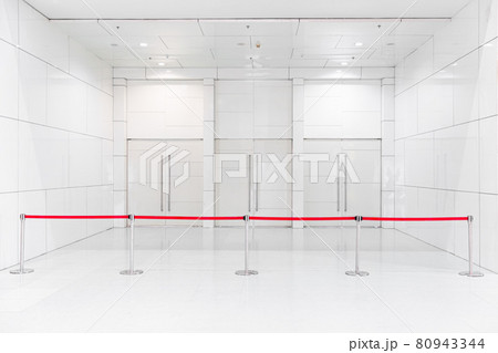 Closed area convention center exhibition hall gate close with retractable stripe belt for prevent people to access. 80943344
