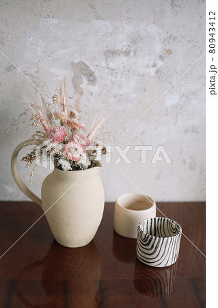 still life with dry flowers in a ceramic vase and a cup. Home decor, interior details 80943412